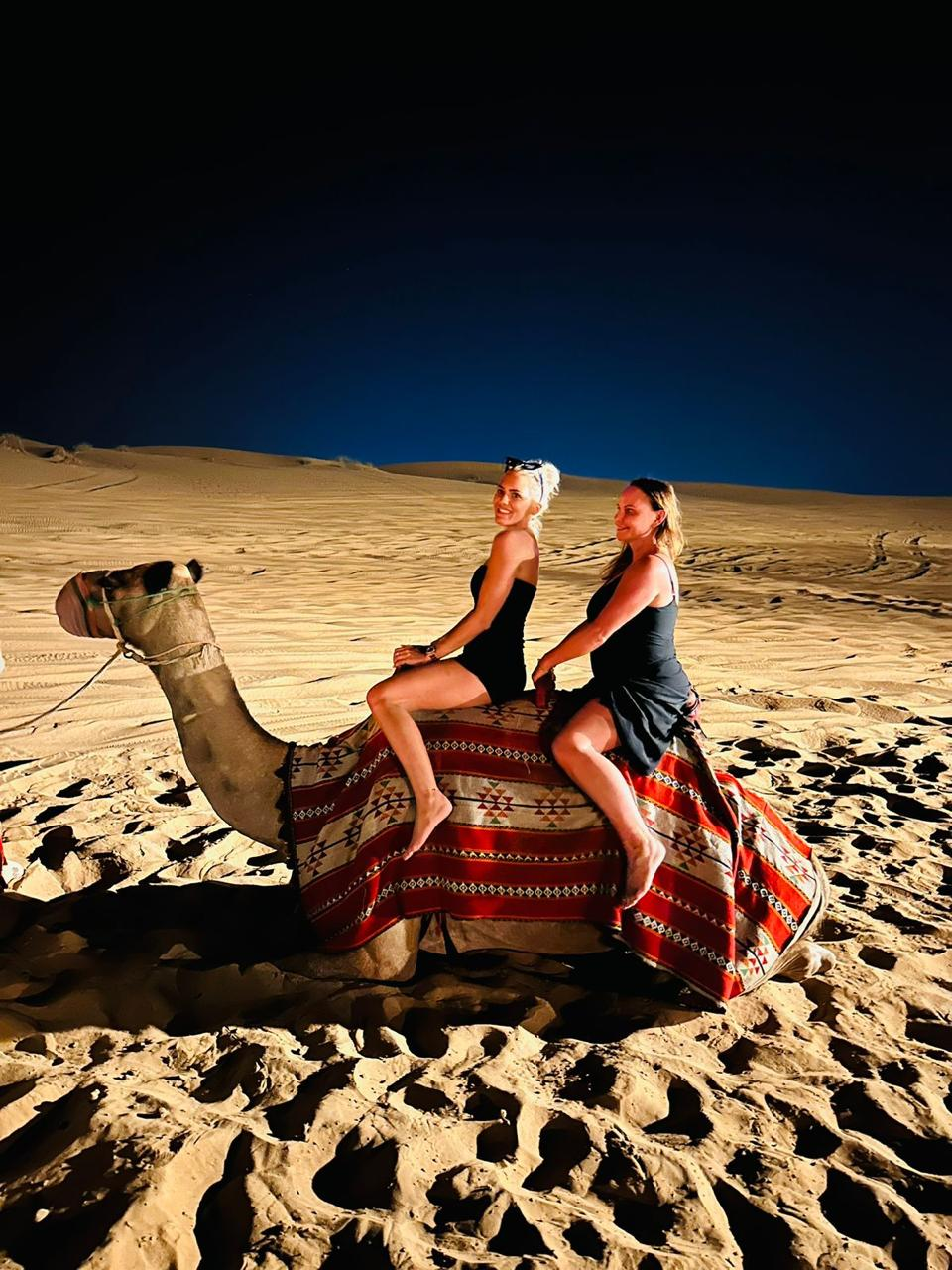 Camel ride in the desert at night